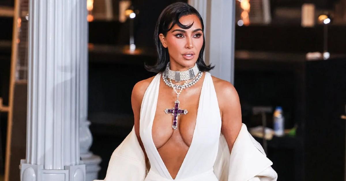 kim kardashian wearing princess diana cross necklace vulgar cleavage