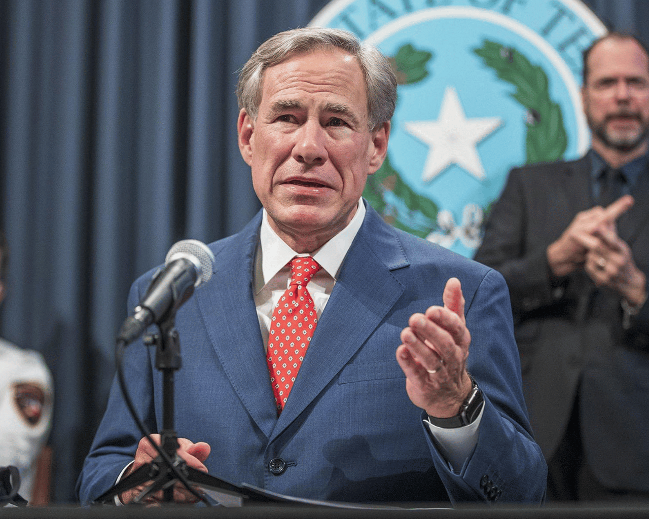 Greg Abbott Faces Backlash After Sending Migrants To Kamala Harris' Home