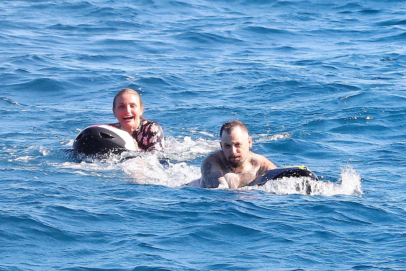 Cameron Diaz seen diving into the Mediterranean in a floral one piece with Benji Madden.