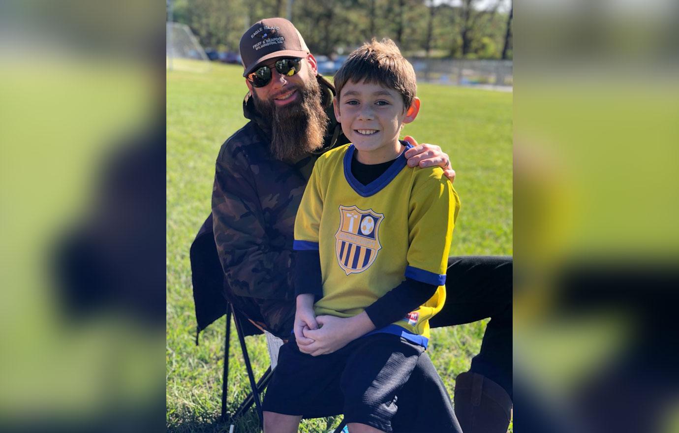 David Eason holds one of his children.