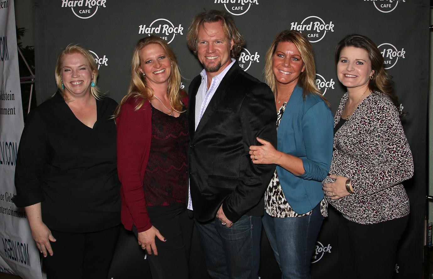 Kody Brown and the wives take a photo together at a press event.