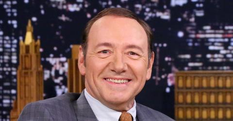 kevin spacey wears a suit and orange tie.