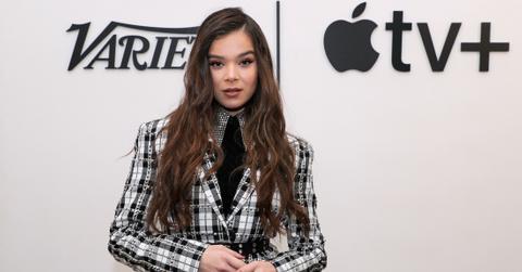 Hailee Steinfeld in a black top, and black and white check jacket.