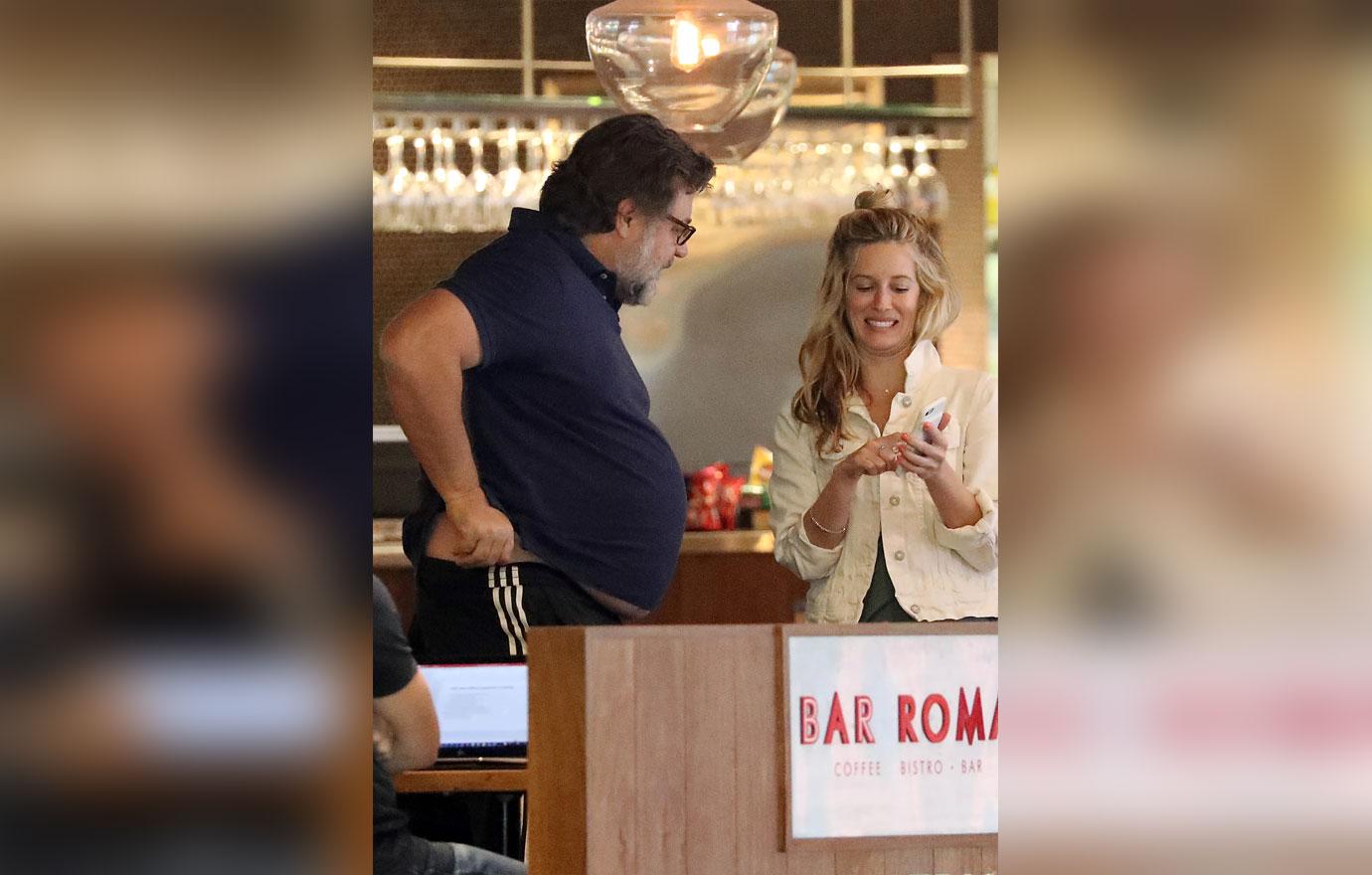 Russell Crowe Shows Off Weight Gain While With New Assistant