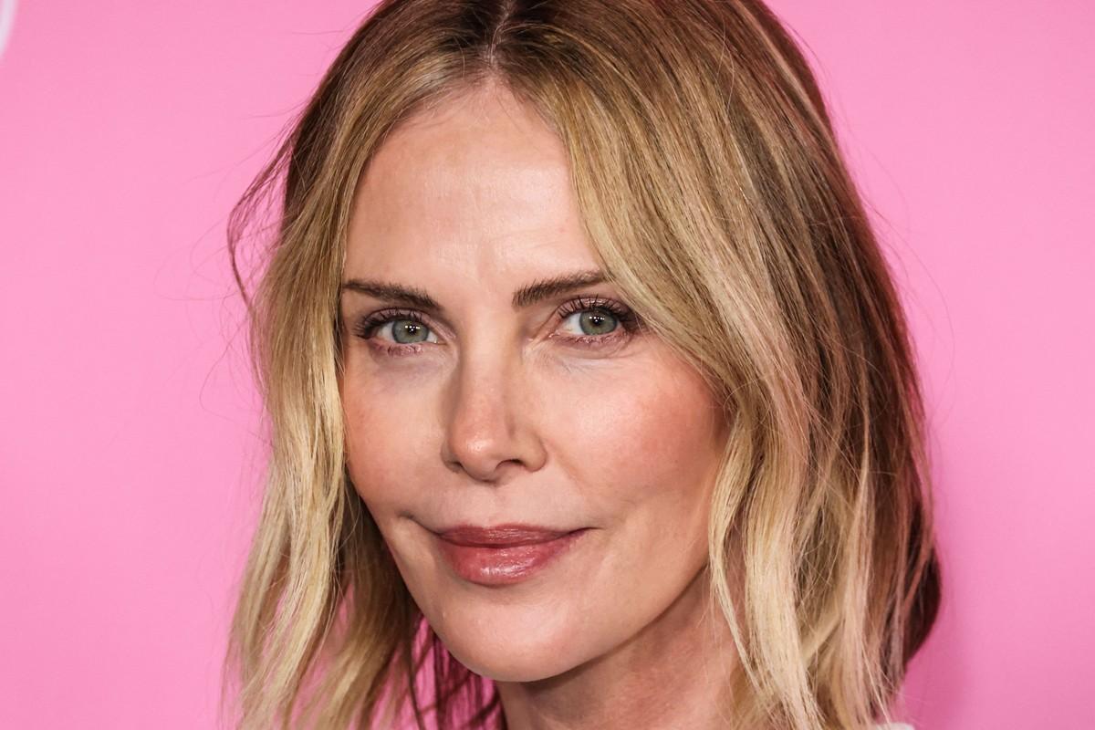 Charlize Theron reportedly turns glam prep into a party with champagne, jokes and smoking before events.