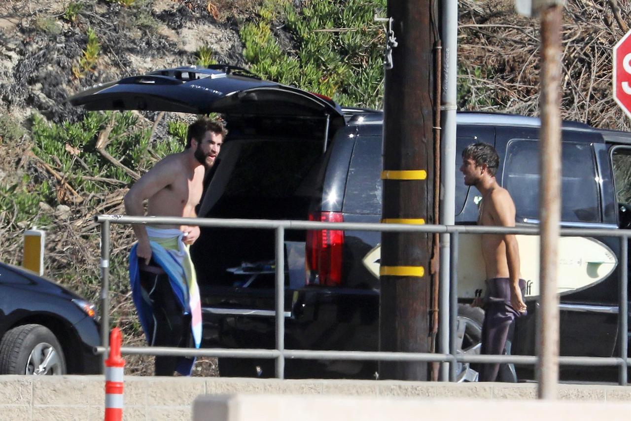 Liam Hemsworth Goes Shirtless In Steamy New Beach Photos