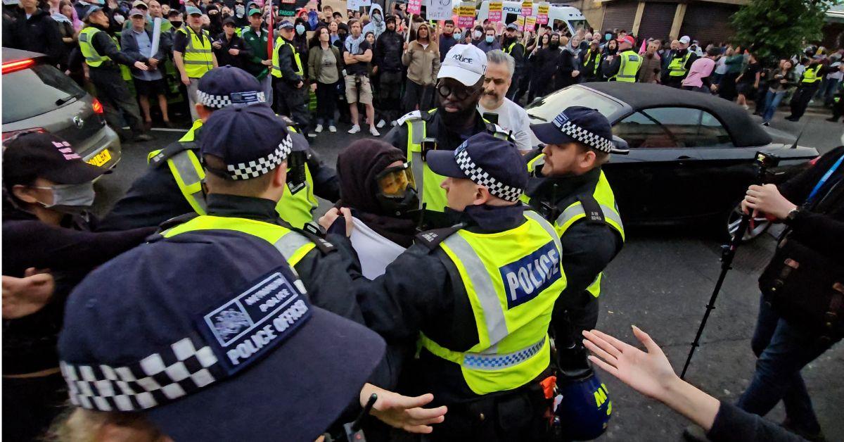 Photo of police stopping a crowd.