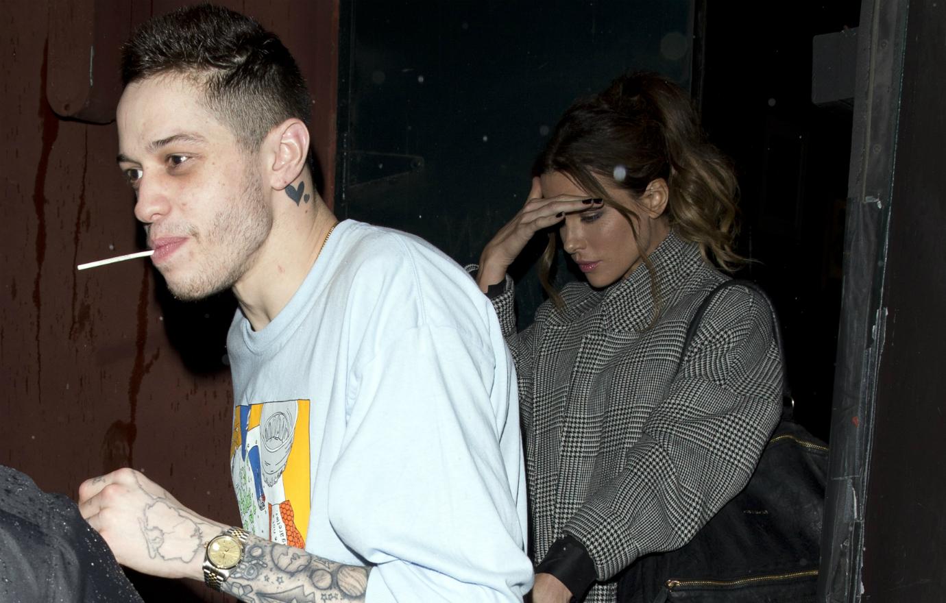 Pete Davidson is seen on a night out with Kate Beckinsale, who was all wrapped up in a grey wool coat, while Davidson wore his trademark T-shirt (and lollipop!).