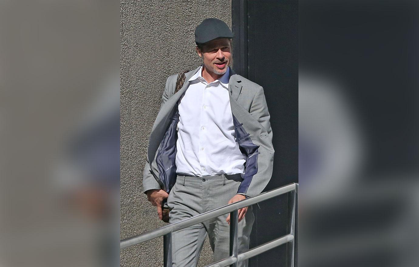 Brad Pitt Emerges Smiling From Office Building