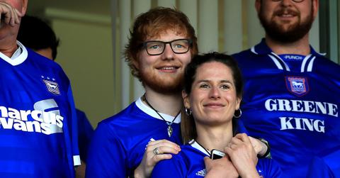 Ed Sheeran and Cherry Seaborn look on during the Sky Bet Championship match between Ipswich Town and Aston Villa at Portman Road.