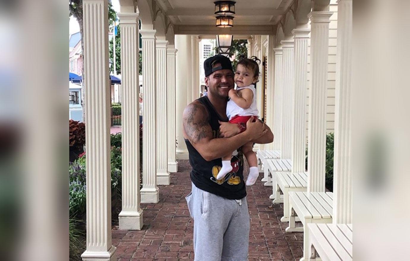 Ronnie Magro Ortiz holding ariana sky at Disney World.