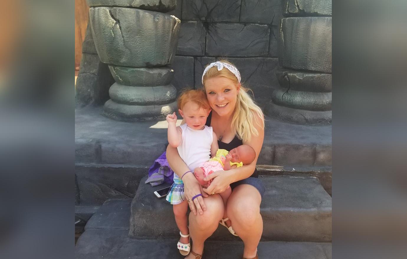 Victoria Messer Sitting On Sculpture Holding Two Young Daughters A Baby and Toddler