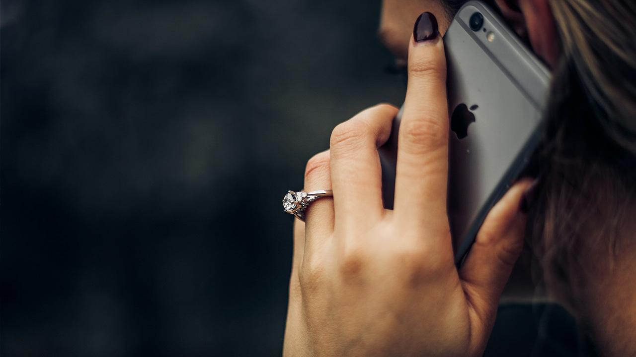 A photo of a woman on the phone.