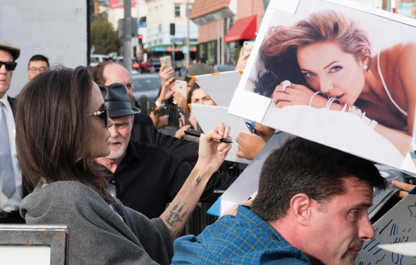 Angelina Jolie signs autographs