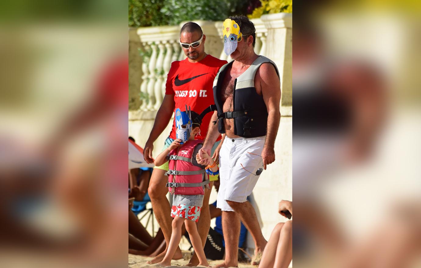 //simon cowell wears transformers mask on jet ski ride with son