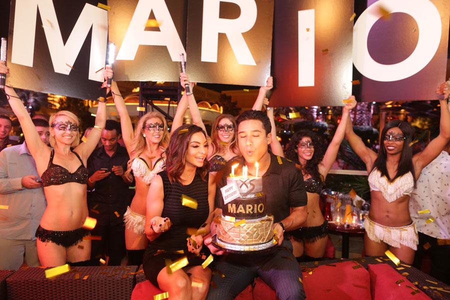 //   mario lopez blows out the candels on his birthday cake at xs nightclub