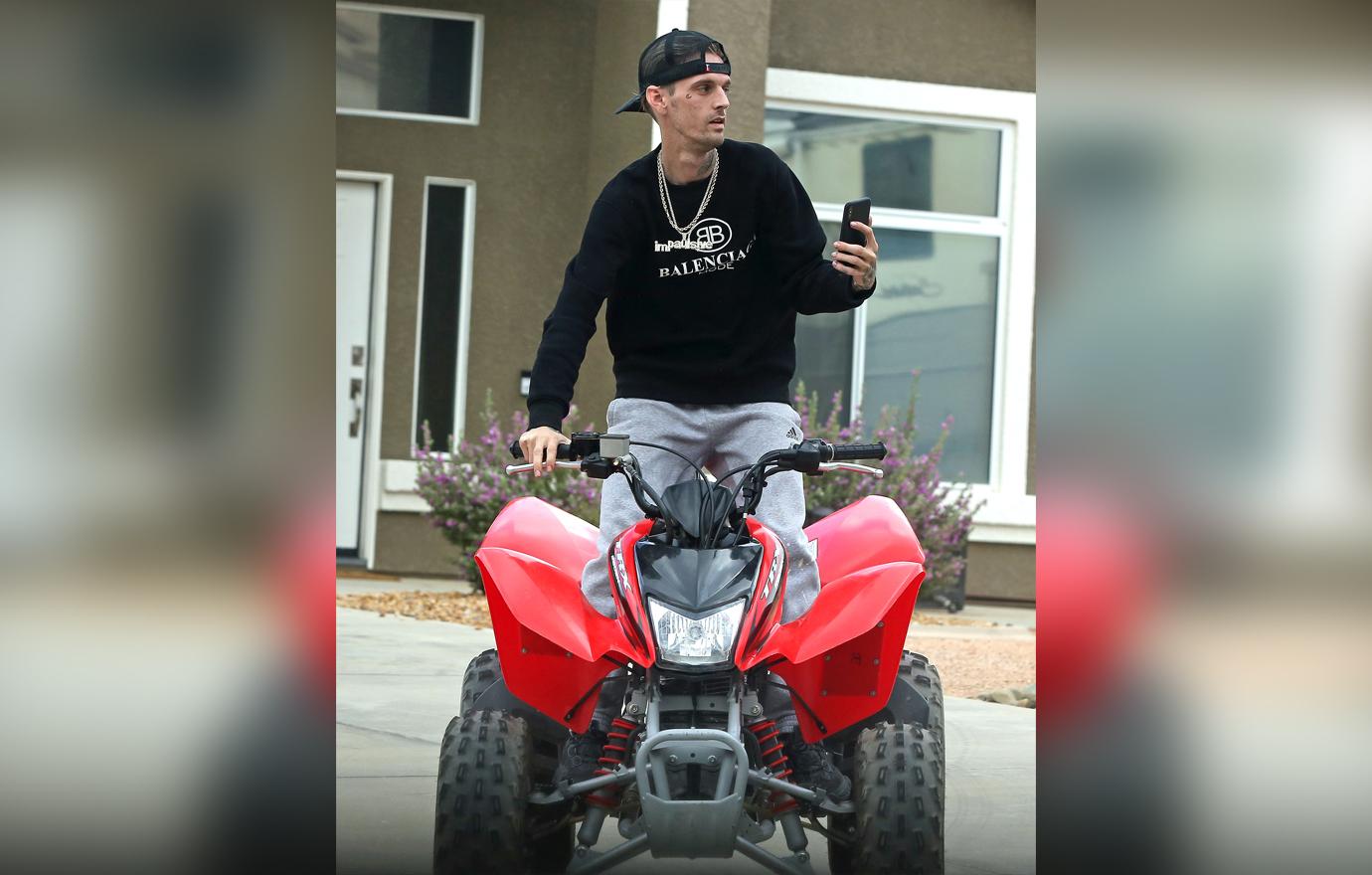 Troubled star Aaron Carter takes a ATV for a ride while sporting his new facial tattoo.