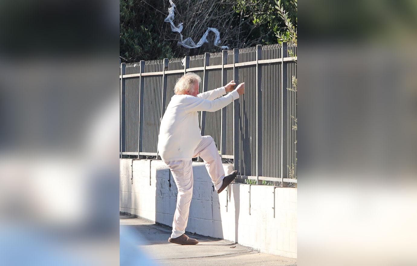 //Nick Nolte Climbs Fence Photos