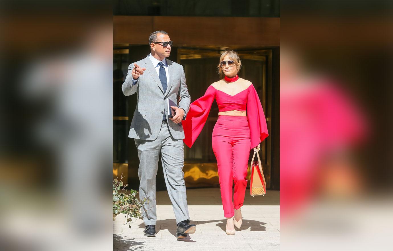 jennifer-lopez-alex-rodriguez-holding-arms-red-shirt-boobs-pants