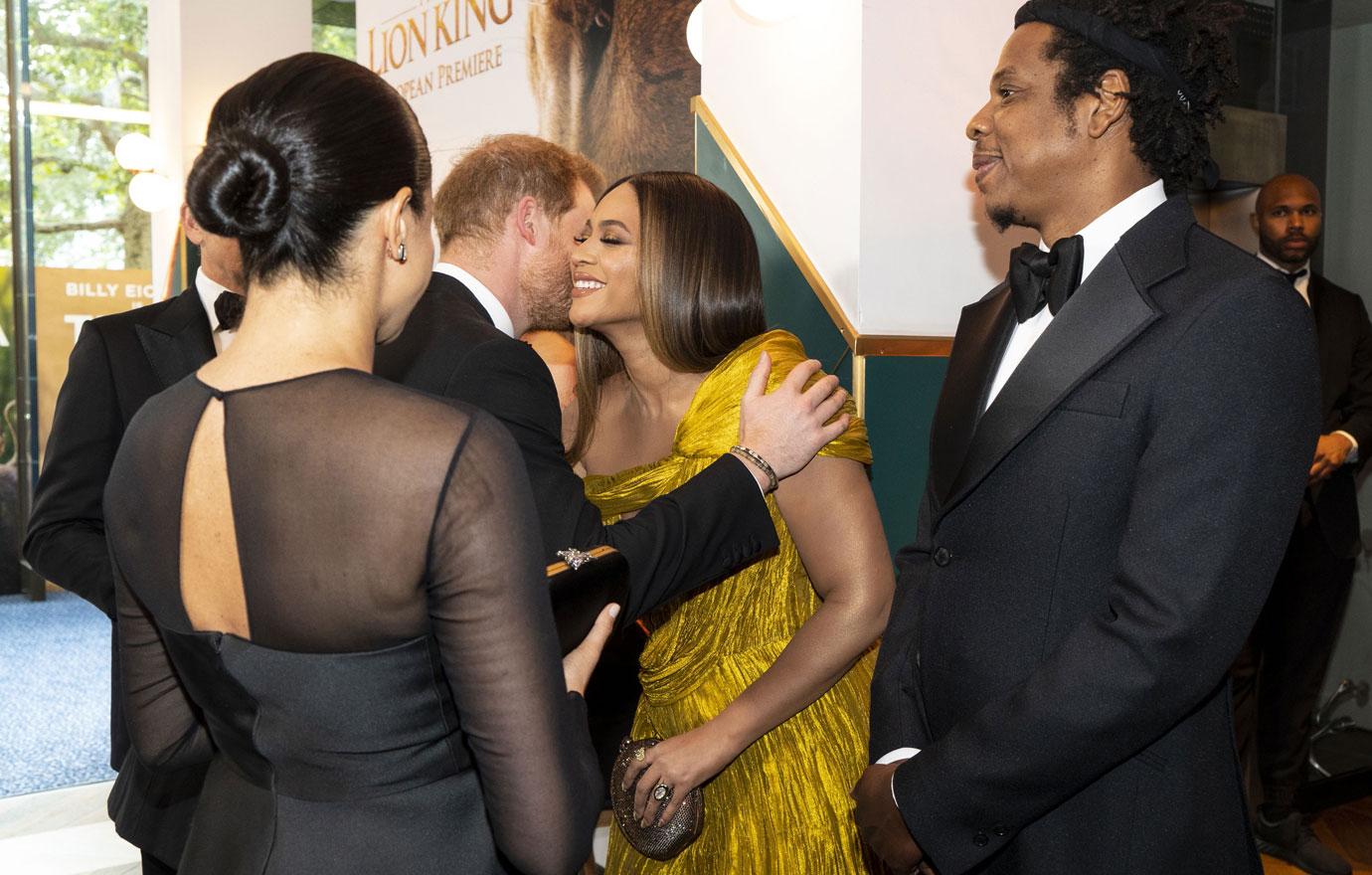 Britain's Meghan, Duchess of Sussex (L) and US rapper Jay-Z (R) stand by as Britain's Prince Harry, Duke of Sussex, (2nd L) greets US singer-songwriter Beyoncé