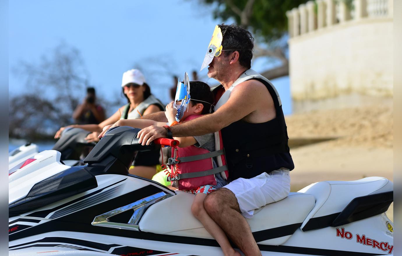 //simon cowell wears transformers mask on jet ski ride with son