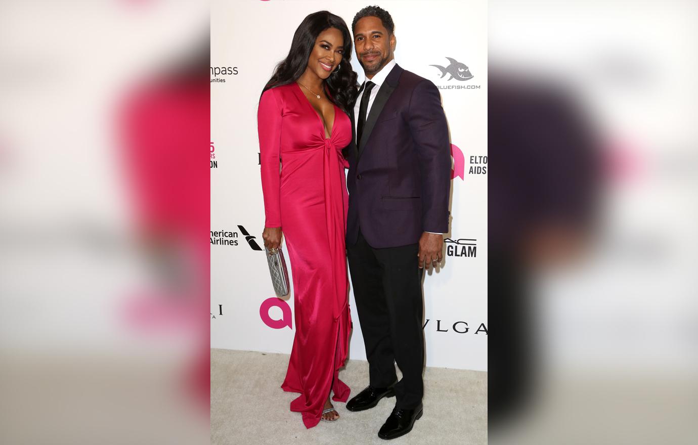 Kenya Moore, left, and Marc Daly arrive at the 2018 Elton John AIDS Foundation Oscar Viewing Party.