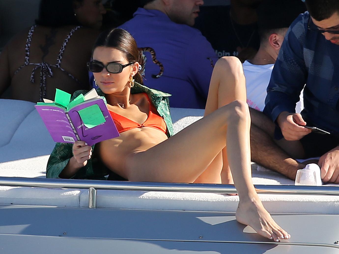 Kendall Jenner wears a tiny red bikini as she takes a ride on the SS Groot yacht in Miami