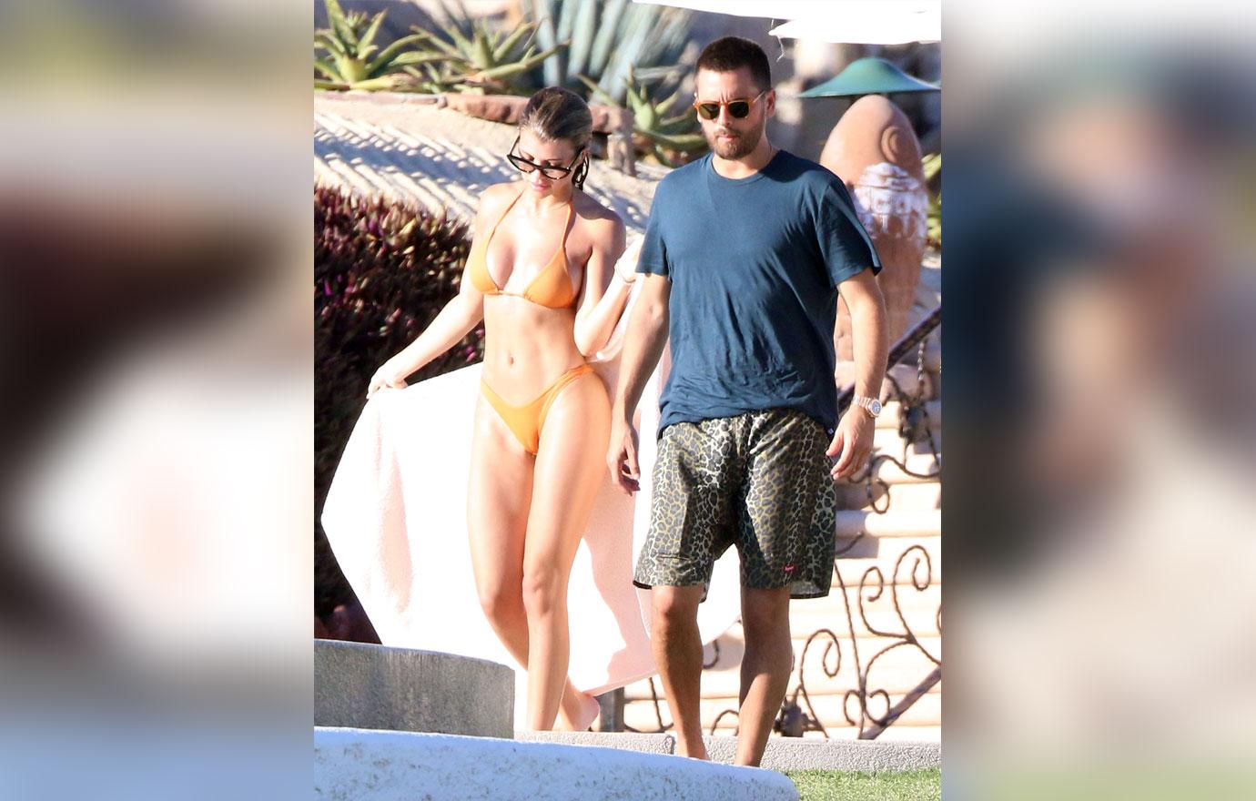 Sofia Richie Walks Wearing an Orange Bikini Besides Scott Disick in T Shirt and Leopard Trunks