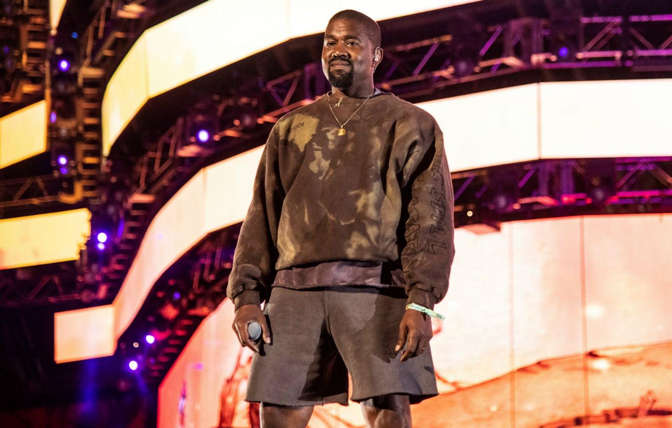 Rapper Kanye West wore a beige sweatshirt and shorts on stage at a recent concert.