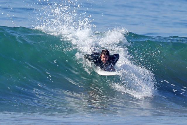 Liam Hemsworth Goes Shirtless In Steamy New Beach Photos