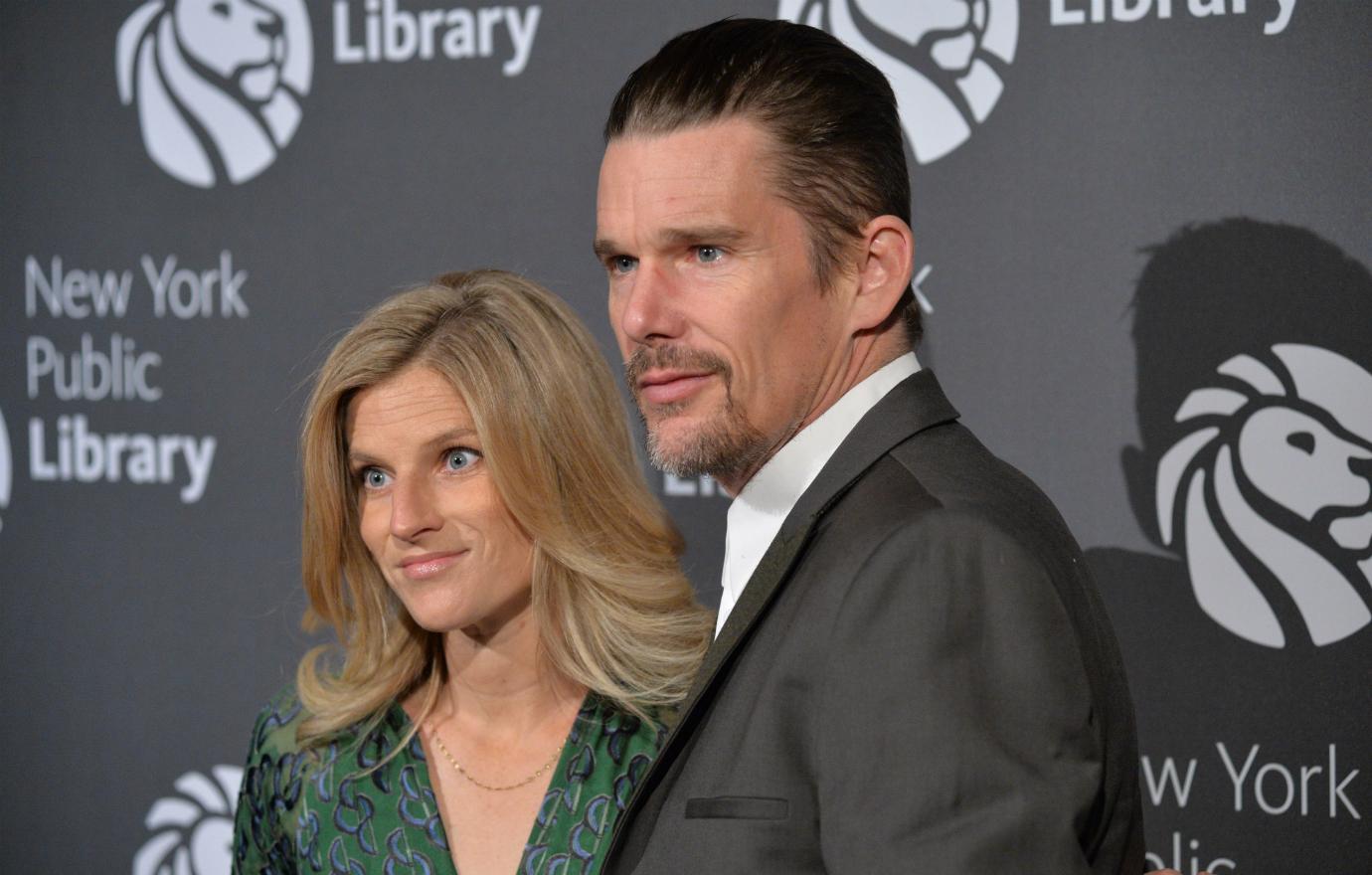 Ethan Hawke, in a grey suit and white shirt, poses with Ryan Shawhughes who wears a green dress.