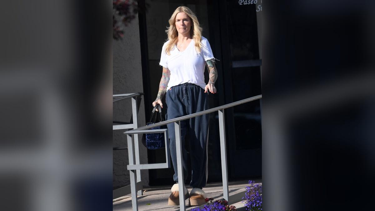 The beach babe's arms are now covered in tattoos.