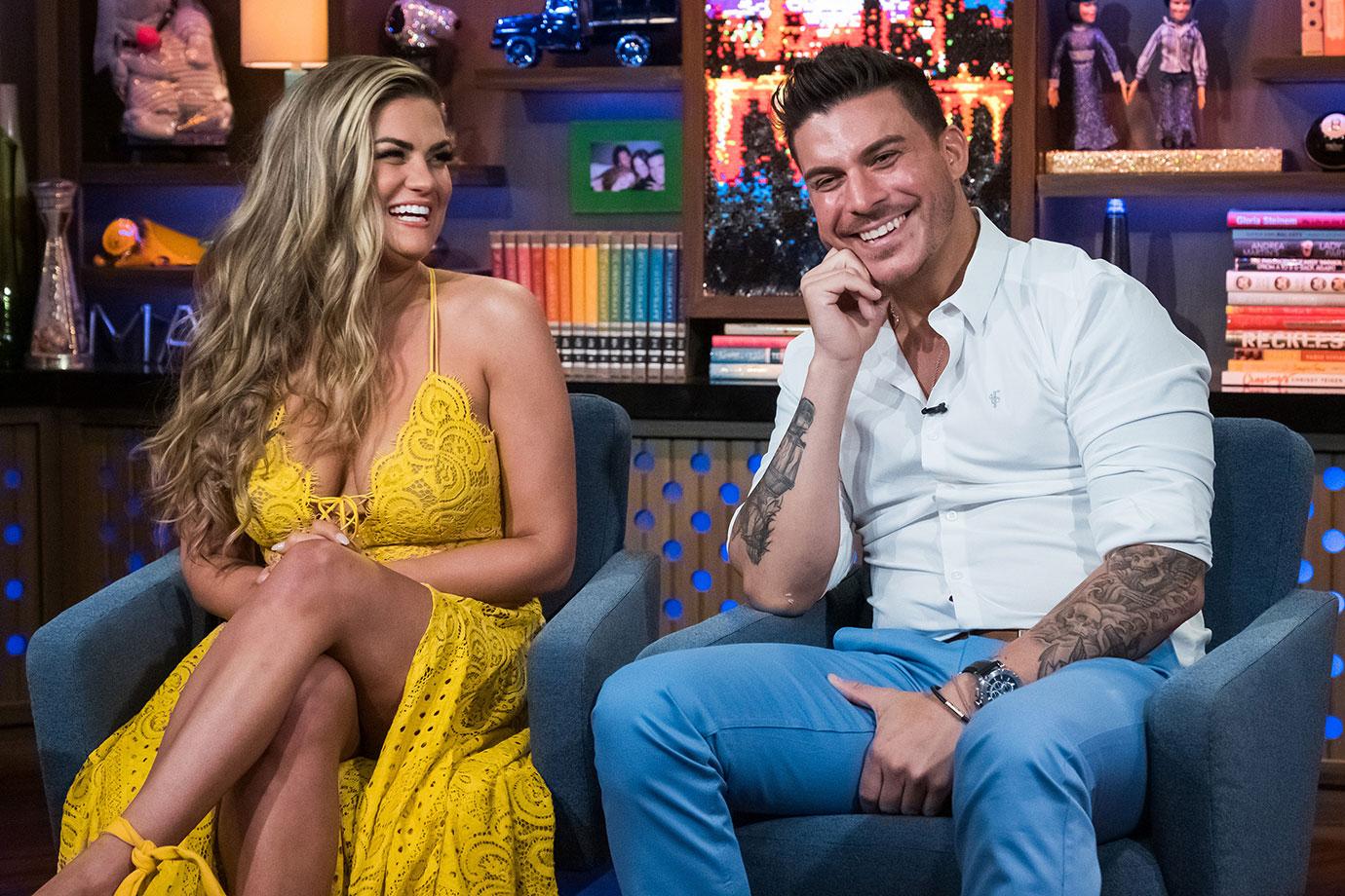 Brittany Cartwright Wearing Yellow Lace Dress While Sitting Next To Jax Taylor WearingWhite Shirt and Light Blue Pants On WWHL