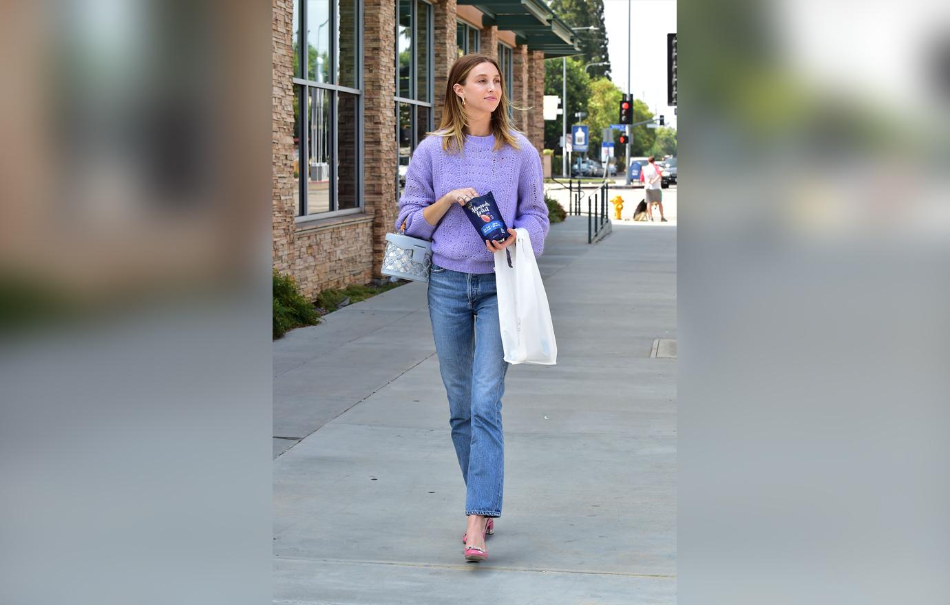 Whitney Port Running Errands In Purple Sweater and Jeans Eating Snacks