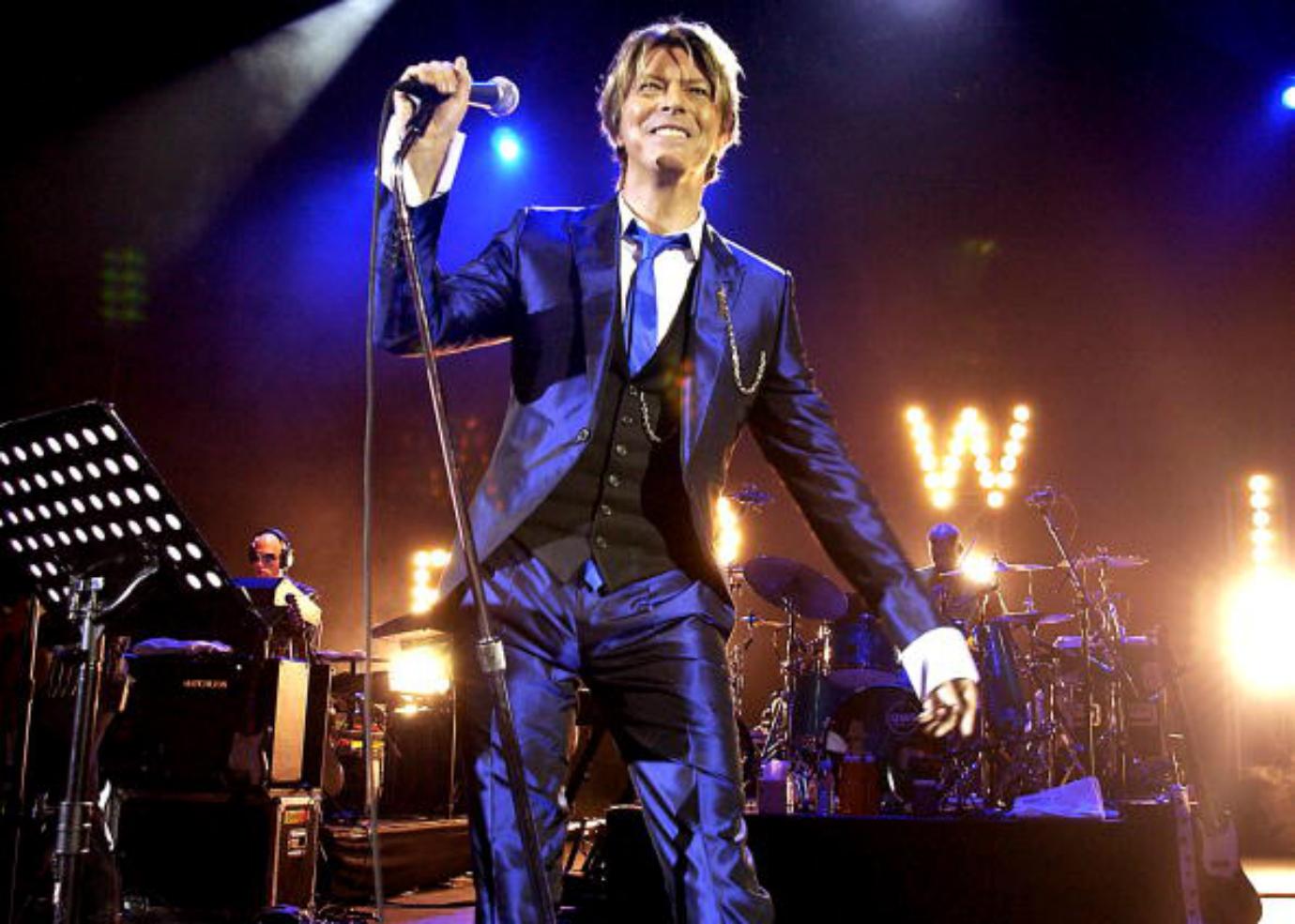 David Bowie performs on stage.