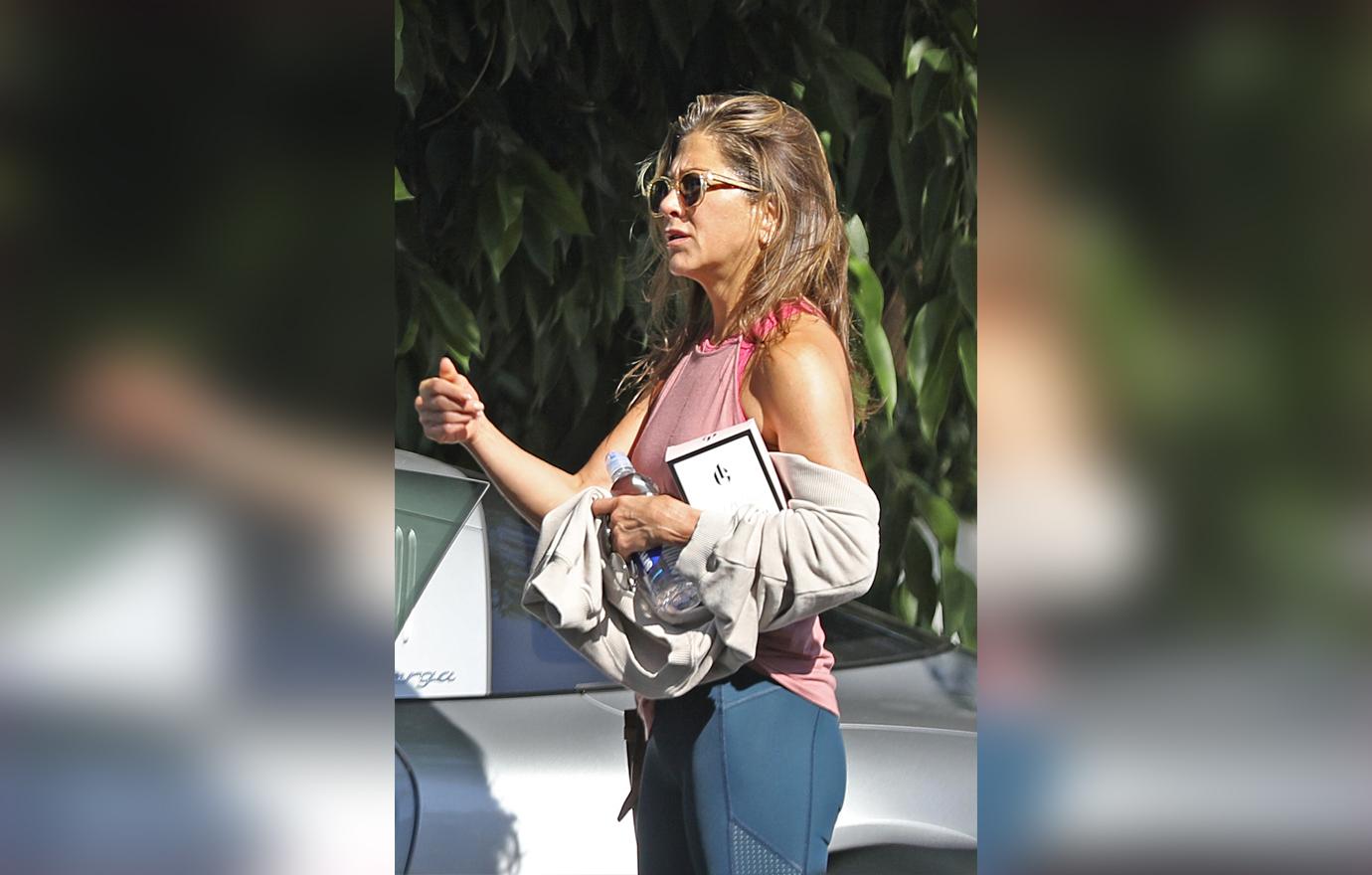 Jennifer Aniston Wearing Sunglasses Pink Tank Top and Navy Leggings Flaunts Body