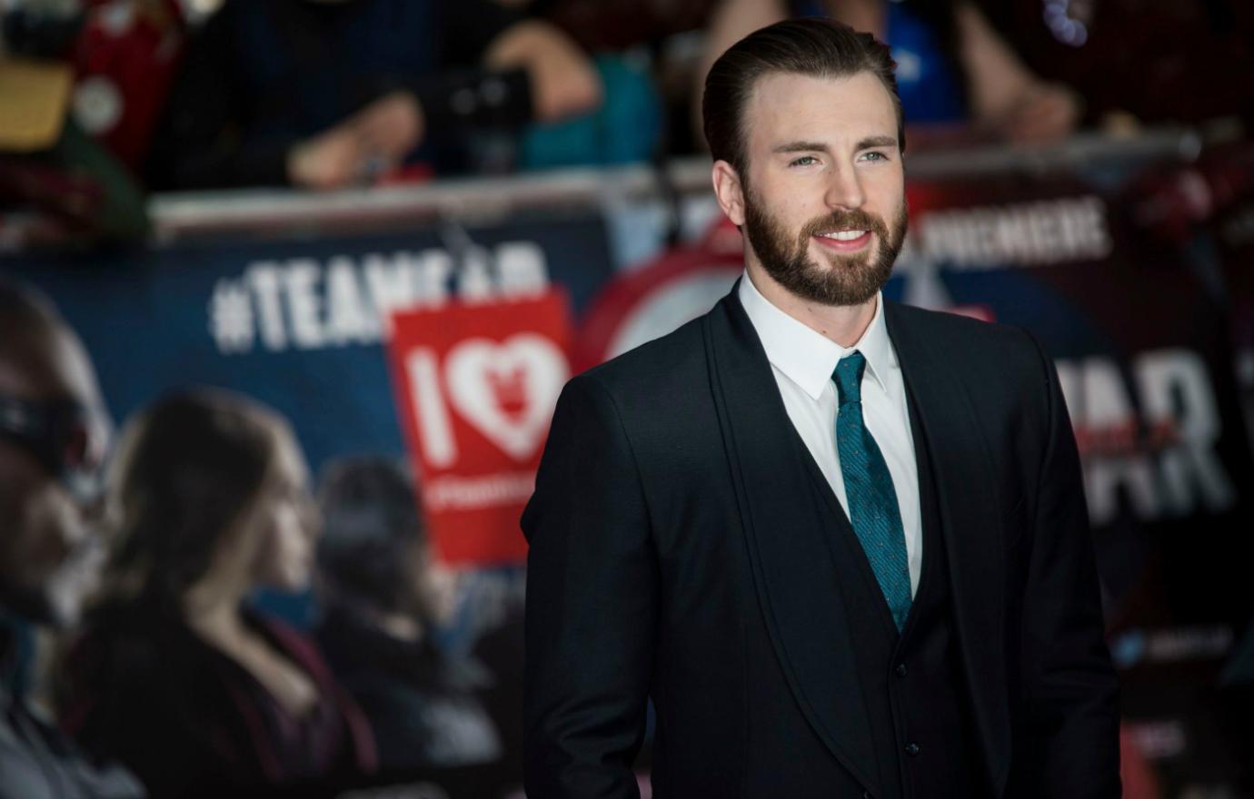 Chris Evans wore a classic black suit with a white shirt and blue tie to a Hollywood event.