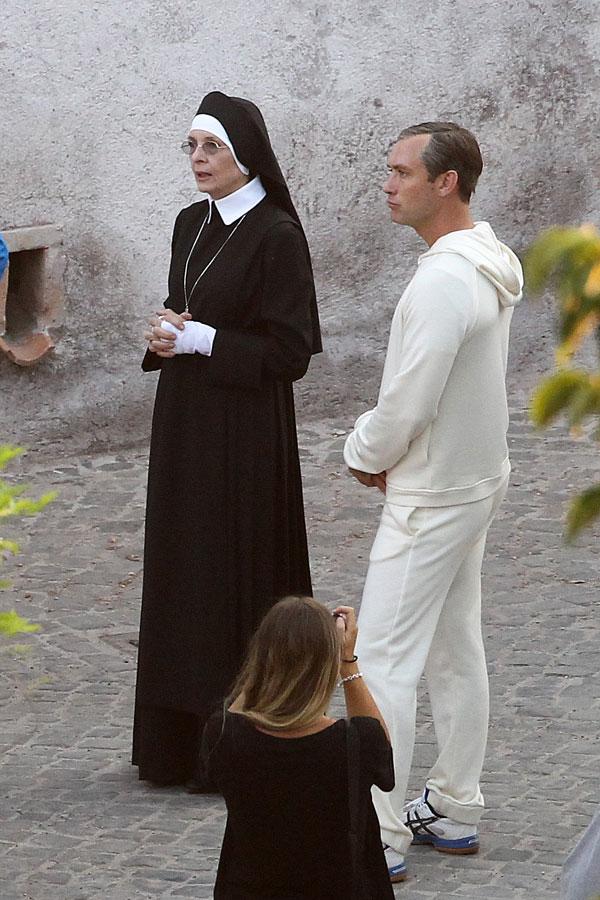 //jude law smokes cigarette dressed up as pope