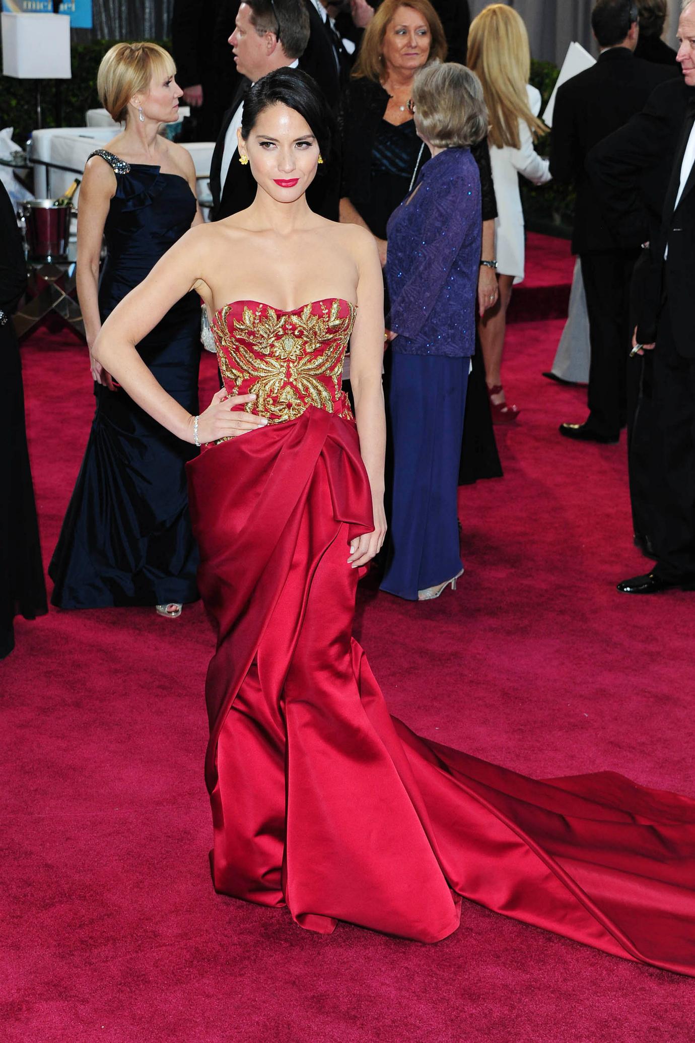 Olivia Munn wears a jeweltoned red dress at the 2013 Oscars.