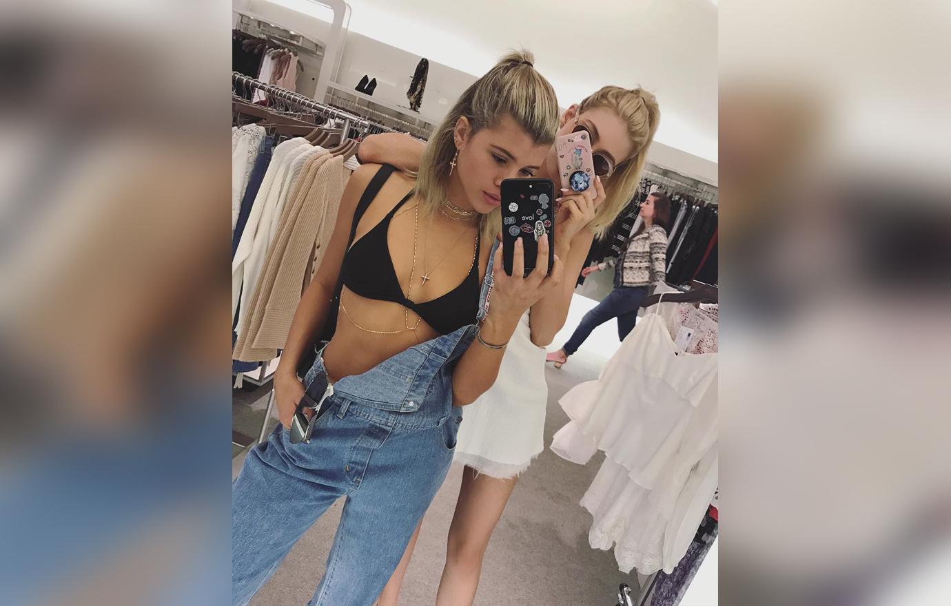 Sofia Richie Selfie Inside a Store Wearing Black Bikini Top With Denim Overalls