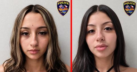 Two sisters were arrested and charged with repeatedly stabbing a mother in a busy intersection.