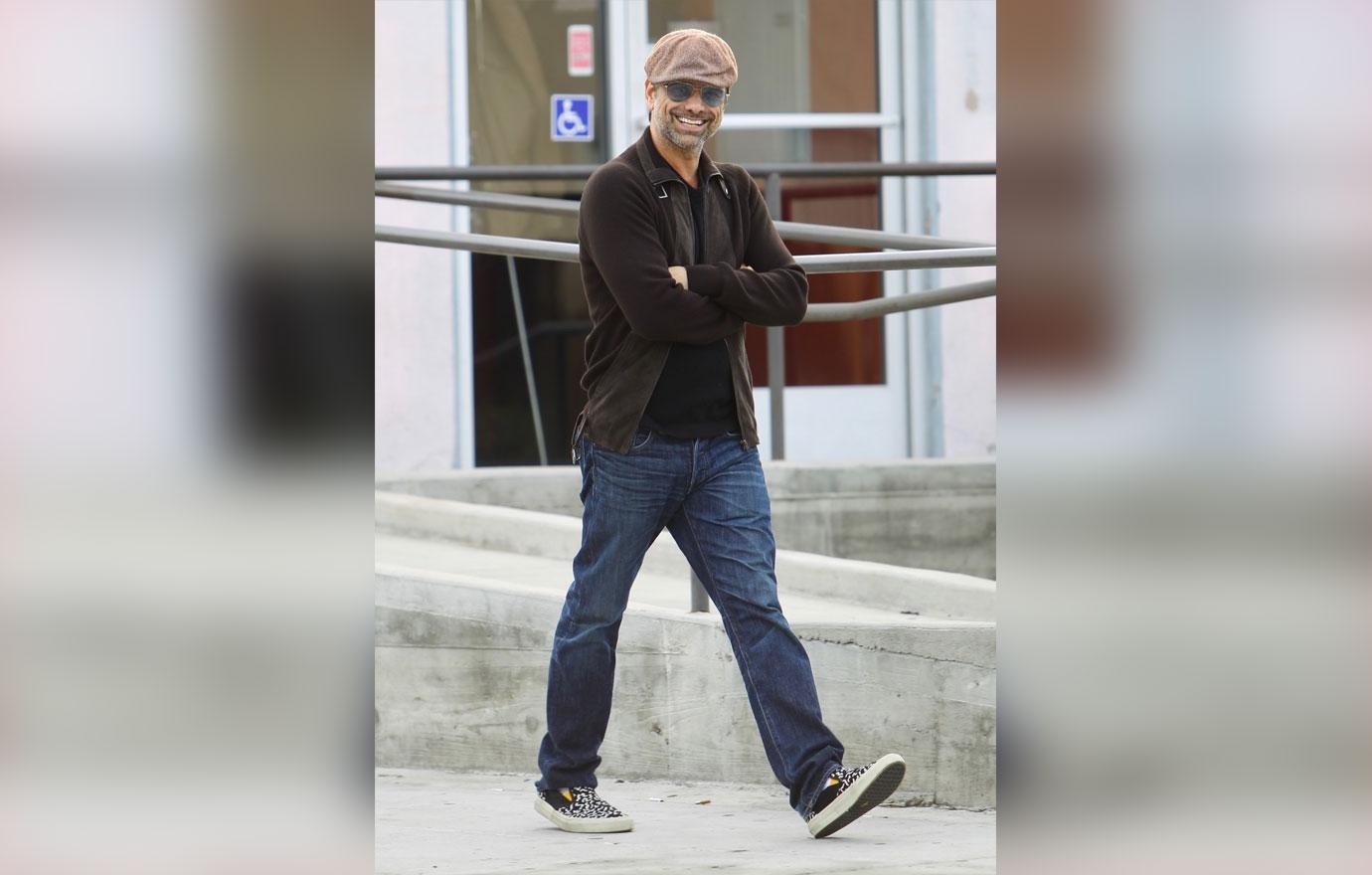 John Stamos Wearing Light Brown Cap, Sunglasses, Dark Brown Sweater and Jeans