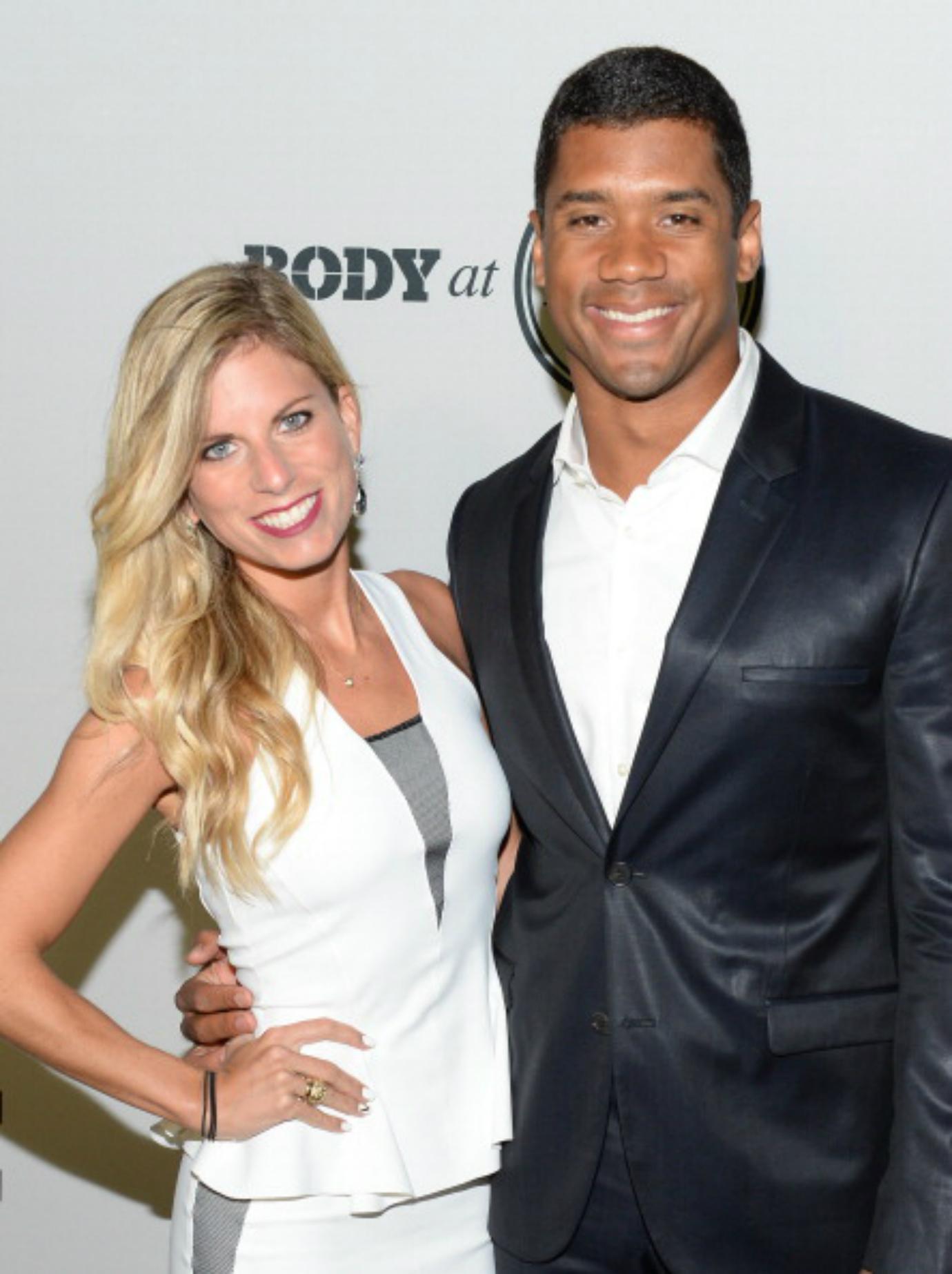 Russel Wilson and Ashton Meem smile for a photo.