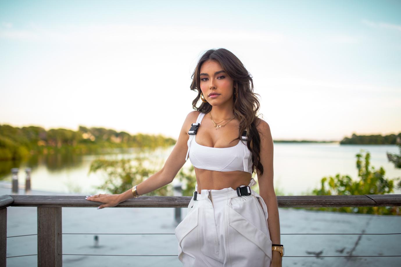 Madison Beer Poses In Front of Landscape Wearing All White Ensemble