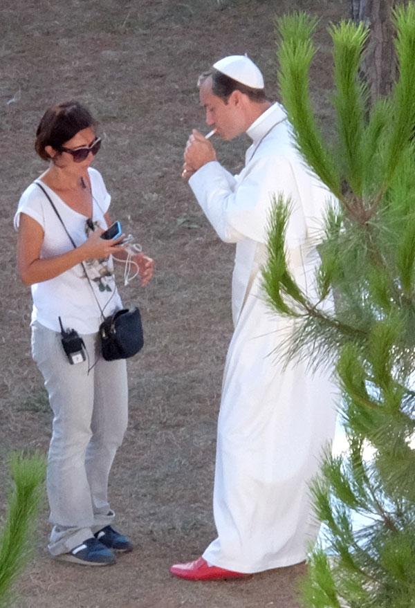 //jude law smokes cigarette dressed up as pope