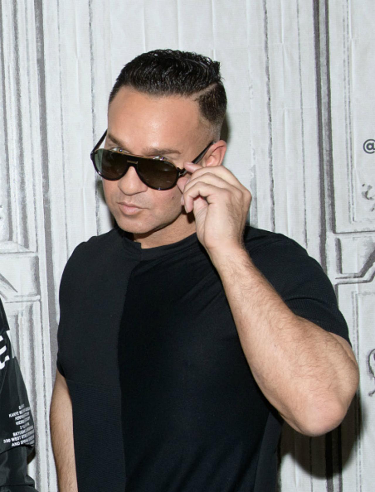 Mike "The Situation" Sorrentino touches his sun glasses as he looks at the camera