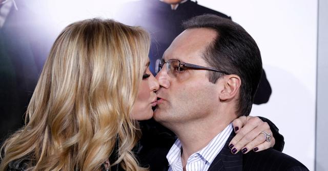 A close up of Taylor & Russell Armstrong kissing on a red carpet.