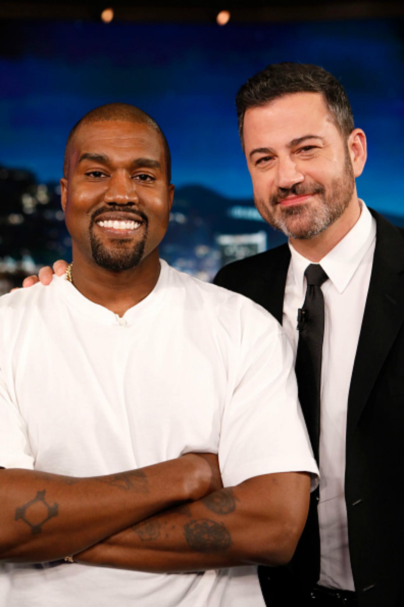 Kanye West and Jimmy Kimmel pose for a photo on set.