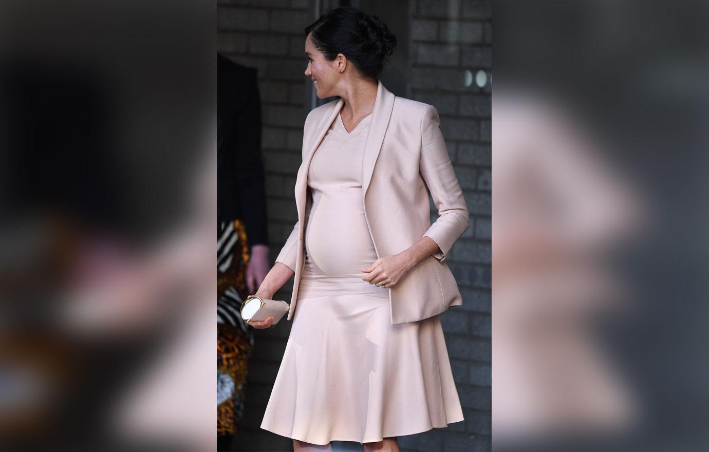 Pregnant Meghan Markle Cradles Stomach During Visit To Royal Theatre