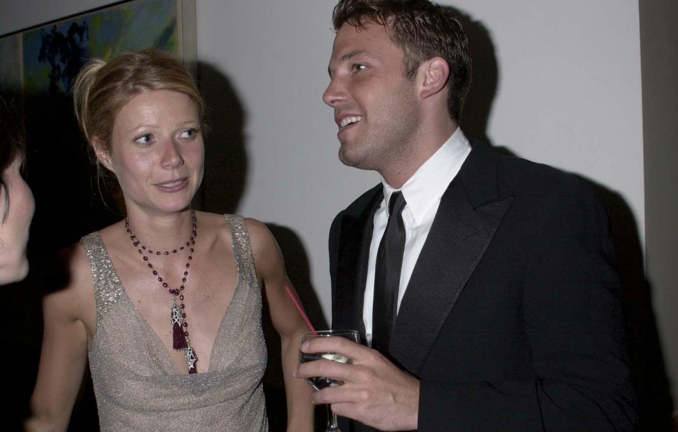 Ben Affleck, who wore a black suit with a white shirt and black tie, stood with a drink in his hand next to girlfriend Gwyneth Paltrow in a sleeveless beige dress.